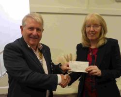 President Mike presenting cheque to  Pam (Rock Foundation)